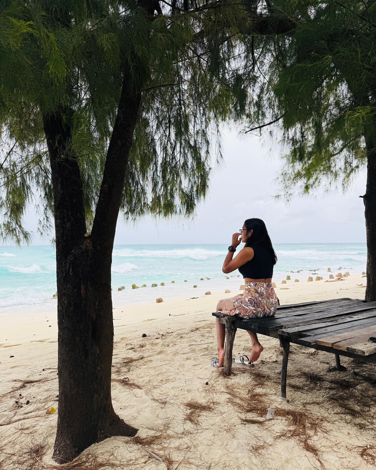Guest resting on a wooden bench on a Lakshadweep beach